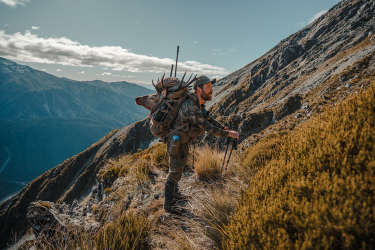 Caribou gear hunter with a mule deer on his caribou gear game bags
