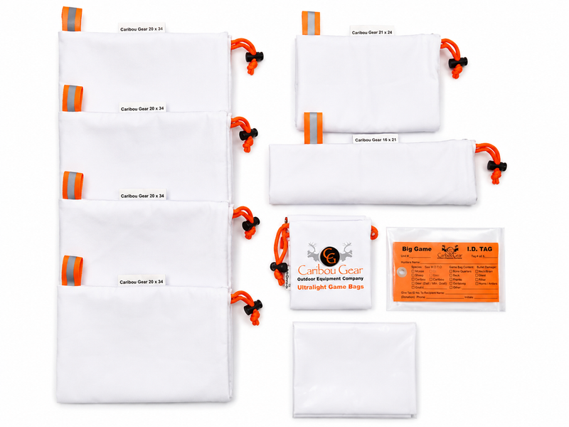 Load image into Gallery viewer, Caribou Gear Magnum Pack Small game bag system laid out with white breathable game bags, orange drawcords, reflective tabs, storage bag, and big game ID tags