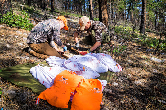 Complete elk game bag system arranged for bone-in quarters and boned-out meat before a Western elk hunt