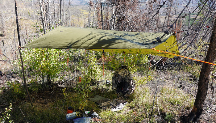 Hunter’s tarp pitched in Western mountain country as a clean gear station and quick weather shelter