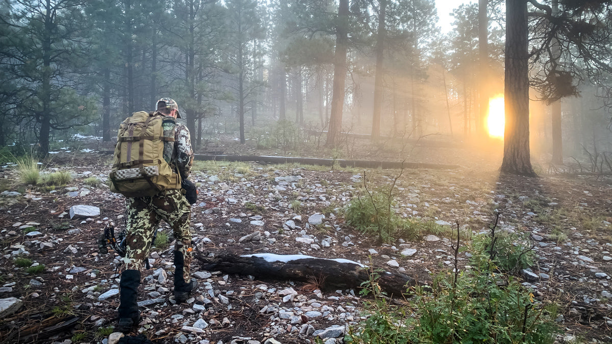 hunter packing out elk on public land with Caribou Gear game bags