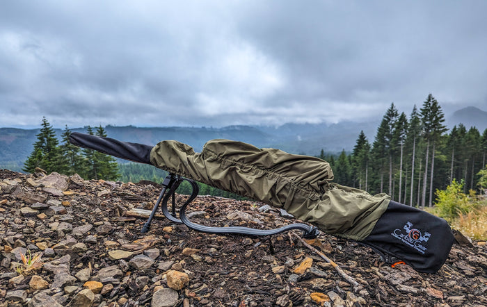 Waterproof rifle cover protecting a scoped hunting rifle from rain mud dust and wet brush during Western travel