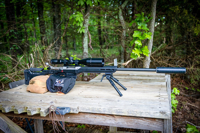 Rifle range day setup with Rifle Shield rifle cover, Ditty Bag organizer, and Hunter’s Tarp used as a clean workspace to protect optics and gear
