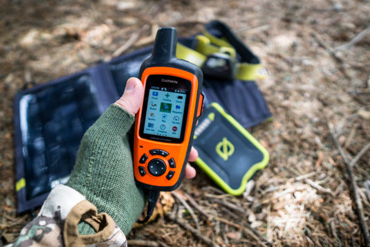 Hunter using a trailhead exit checklist after scouting with notes, Ditty Bags, Hunter’s Tarp, and Waterproof Rifle Cover