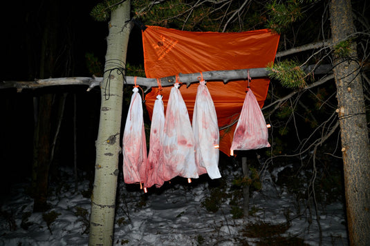 The Hunters Tarp Blocking Snow From Caribou Gear Game Bags