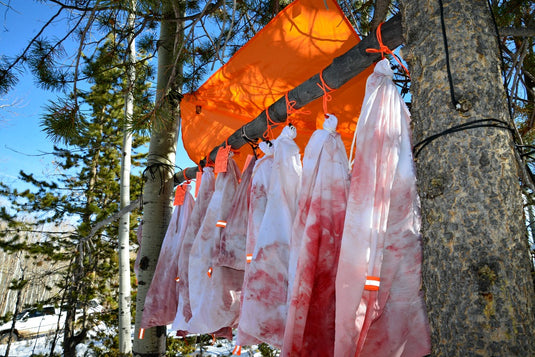 The Hunters Tarp Blocking Rain From Caribou Gear Game Bags